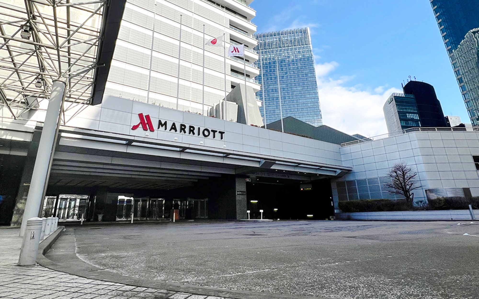 Marriott hotel entrance in Nagoya with modern architecture and city skyline.