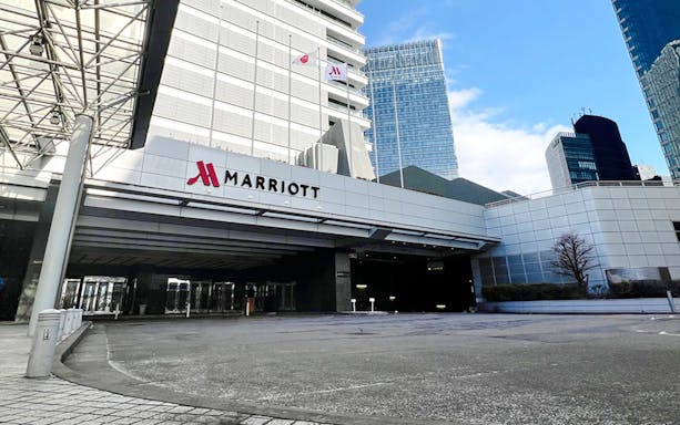 Marriott hotel entrance in Nagoya with modern architecture and city skyline.