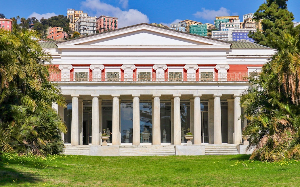 Villa Pignatelli facade with columns and surrounding greenery in Naples, Italy.