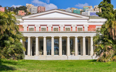 Villa Pignatelli facade with columns and surrounding greenery in Naples, Italy.