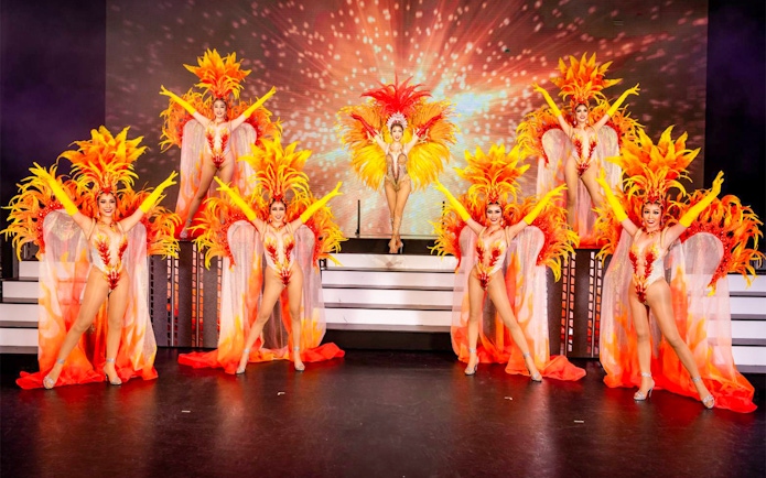 Performers in vibrant costumes at Simon Cabaret Show, Phuket.
