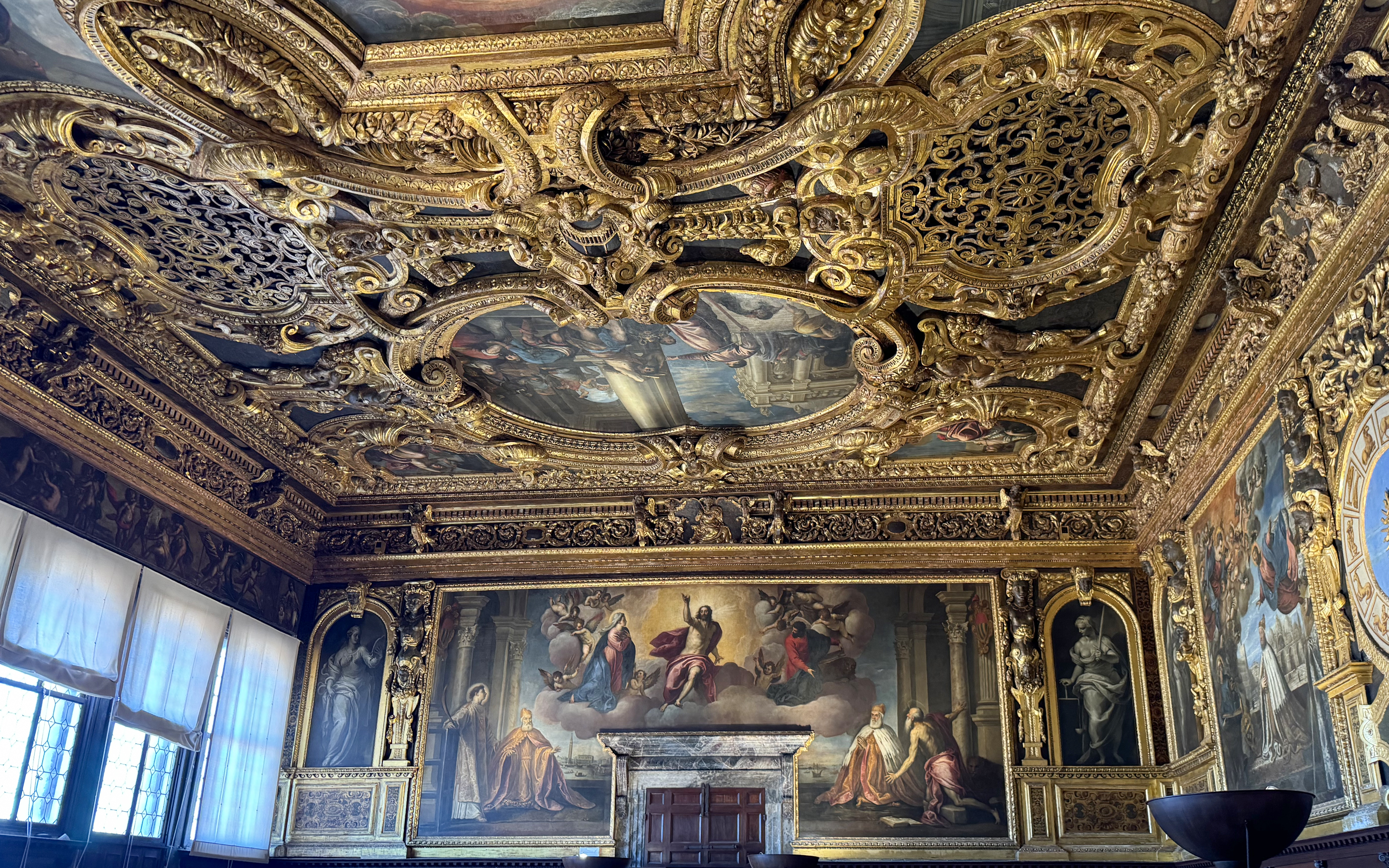 Doge's Palace interior with ornate gilded ceiling and Renaissance paintings, Venice.