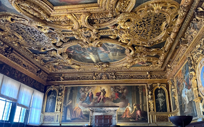 Doge's Palace interior with ornate gilded ceiling and Renaissance paintings, Venice.