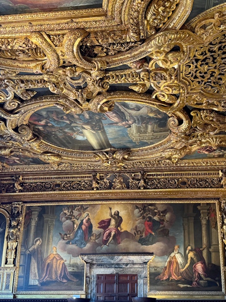 Doge's Palace interior with ornate gilded ceiling and Renaissance paintings, Venice.