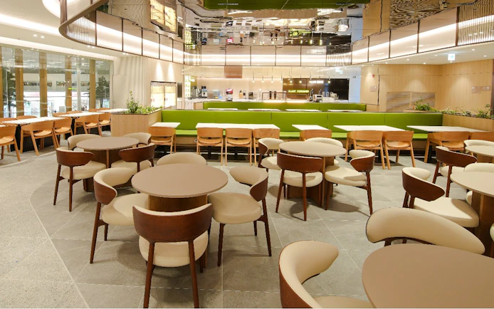 Plaza Premium Lounge interior in South Korea with wooden chairs and modern decor.