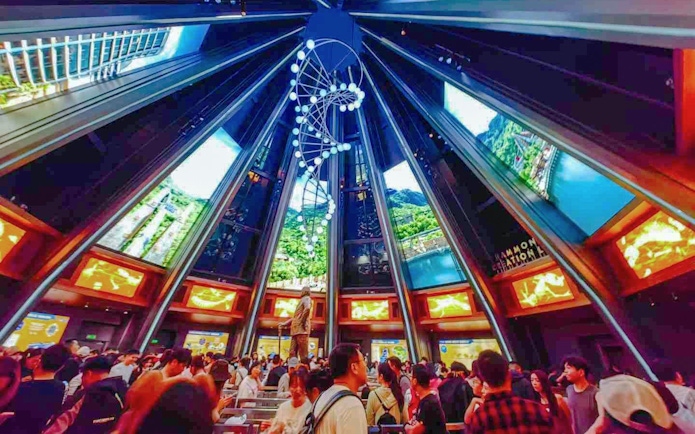 Indoor queue area for Jurassic World Adventure ride at Universal Studios Beijing, featuring a DNA helix sculpture.