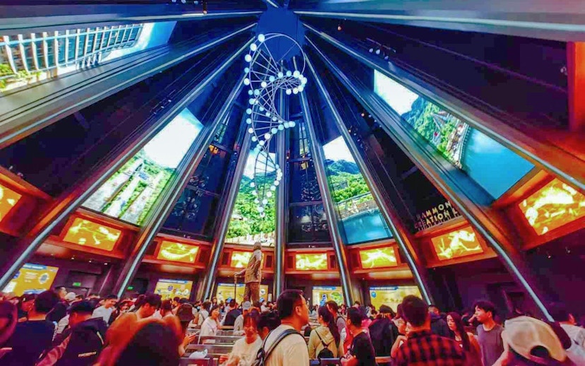 Indoor queue area for Jurassic World Adventure ride at Universal Studios Beijing, featuring a DNA helix sculpture.