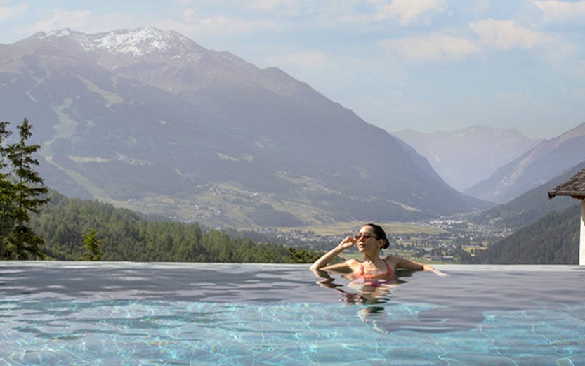 QC Terme Bagni Vecchi di Bormio thermal baths with mountain view in Italy.
