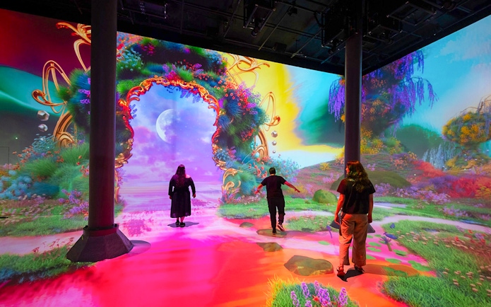 Guests exploring digital art exhibits at ARTECHOUSE New York.