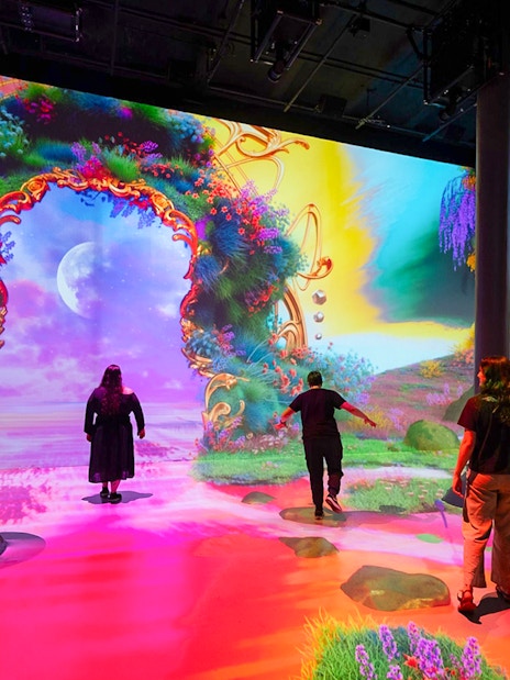 Guests exploring digital art exhibits at ARTECHOUSE New York.