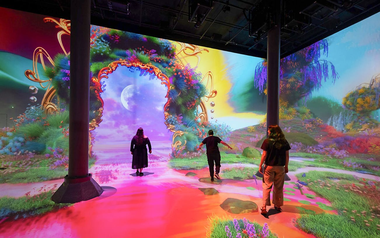 Guests exploring digital art exhibits at ARTECHOUSE New York.