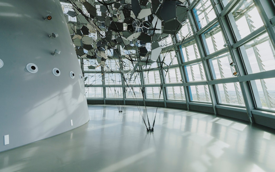 Interior view of Glories Skyline Tower with geometric ceiling design and large windows.