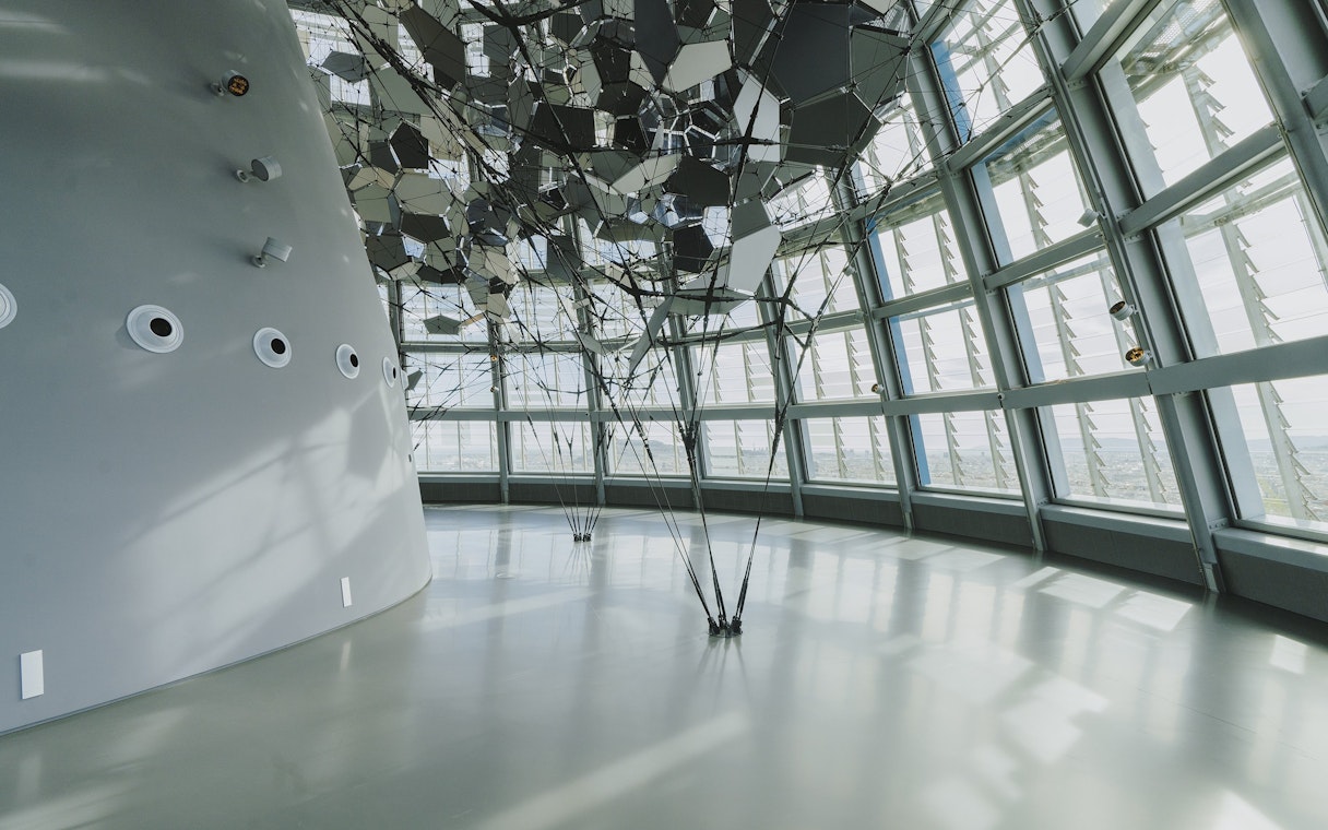 Interior view of Glories Skyline Tower with geometric ceiling design and large windows.