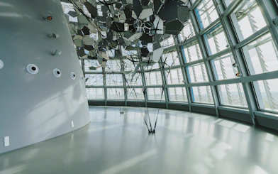 Interior view of Glories Skyline Tower with geometric ceiling design and large windows.