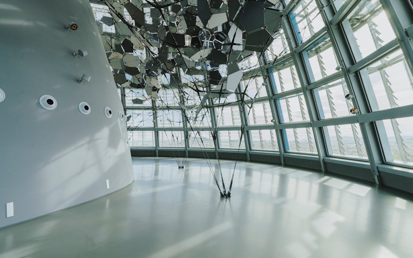 Interior view of Glories Skyline Tower with geometric ceiling design and large windows.