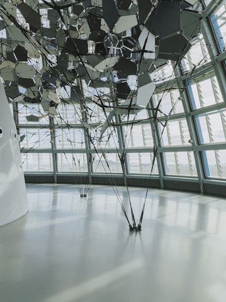 Interior view of Glories Skyline Tower with geometric ceiling design and large windows.