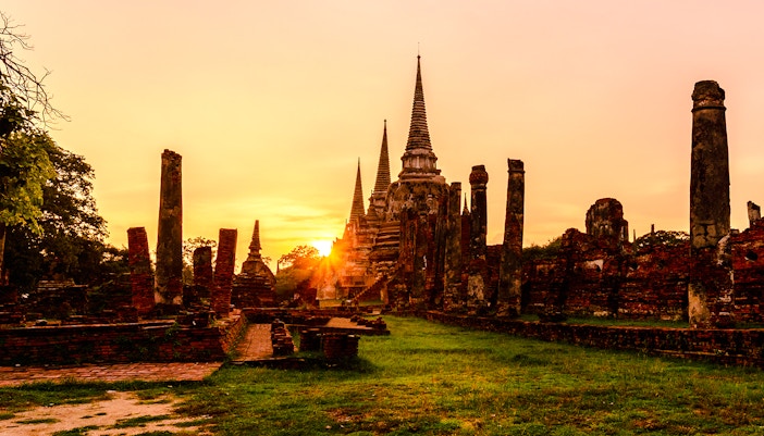 Wat Phra Sri Sanphet ruins at sunset in Ayutthaya Historic Park, Thailand.