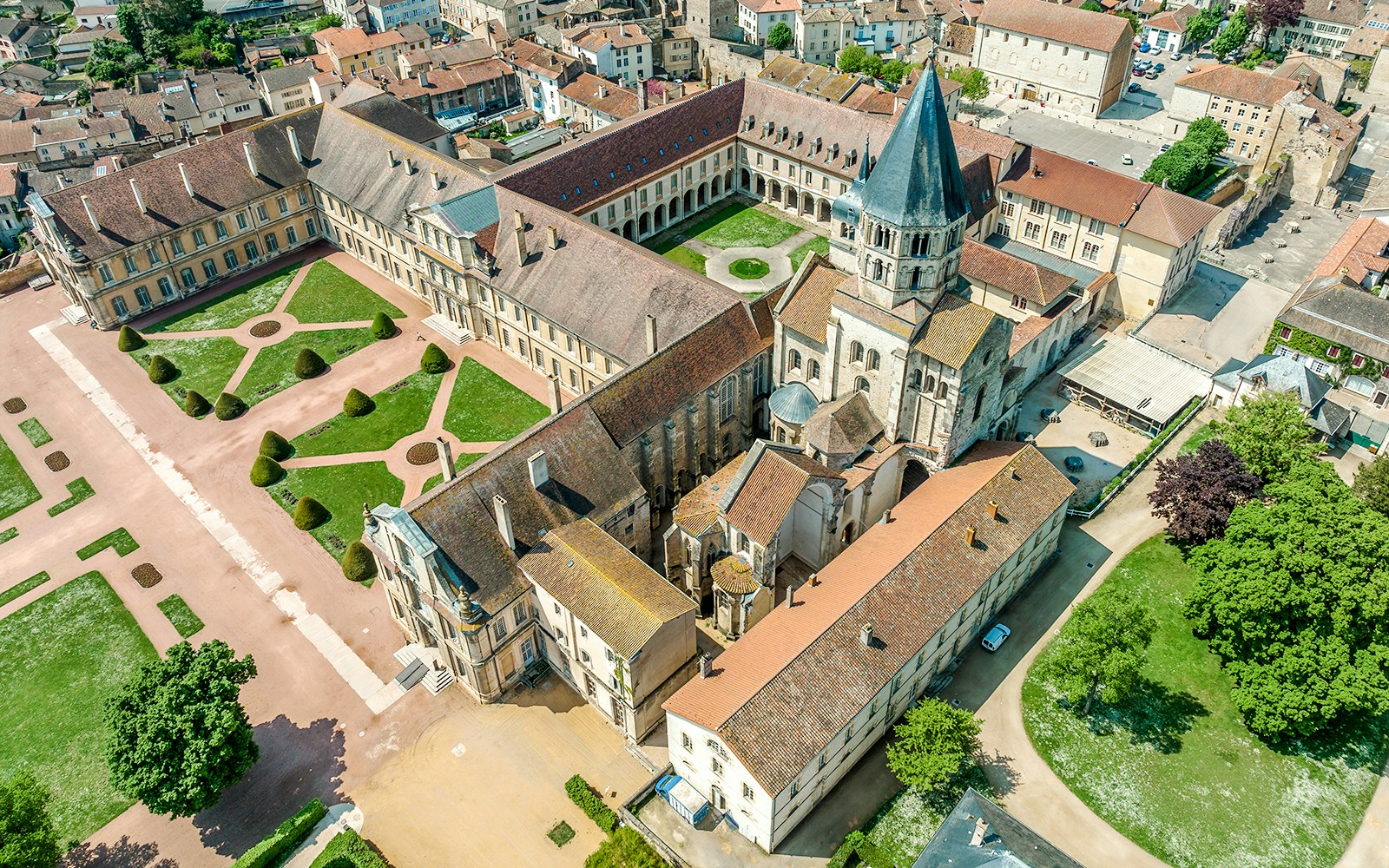Aerial view of Abbaye de Cluny complex in Lyon, France, showcasing historic architecture and gardens.