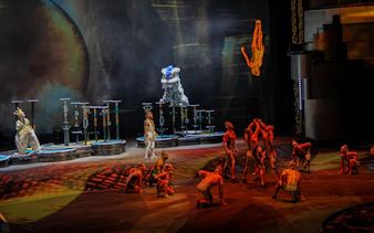 Acrobats performing a banquine flip at La Perle show in Dubai.