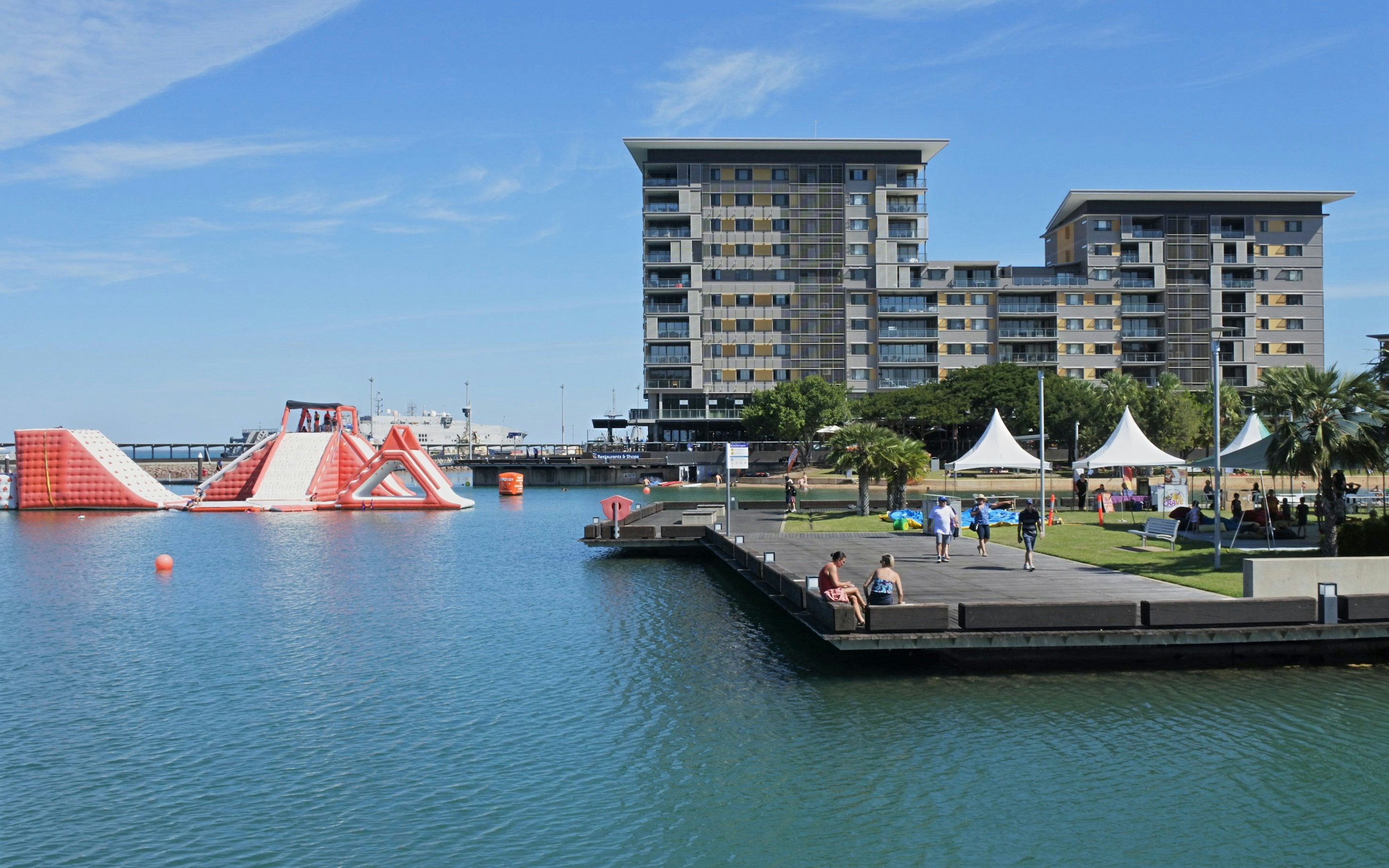 Darwin Waterfront Precinct with inflatable water park and modern buildings, Northern Territory, Australia.