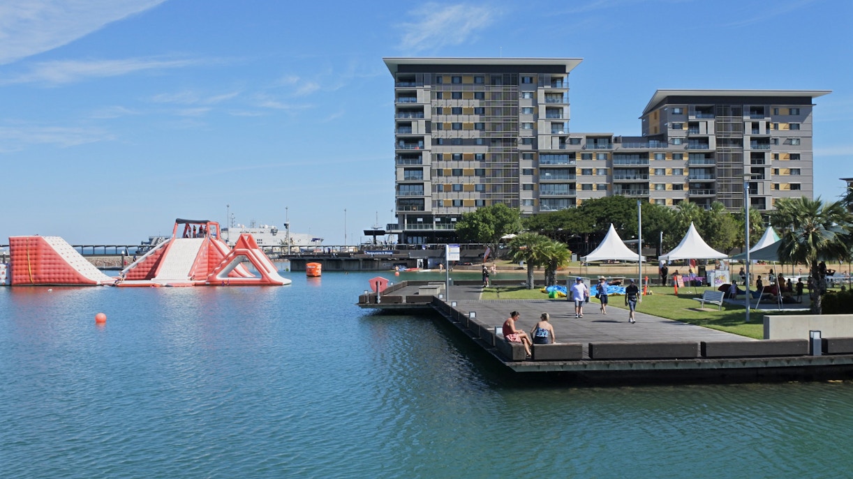 Darwin Waterfront Precinct with inflatable water park and modern buildings, Northern Territory, Australia.
