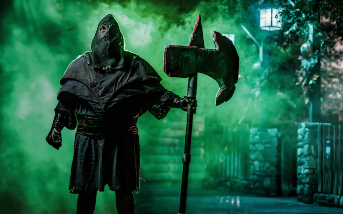 Hooded figure with axe at Knotts Berry Scary Farm, Southern California.
