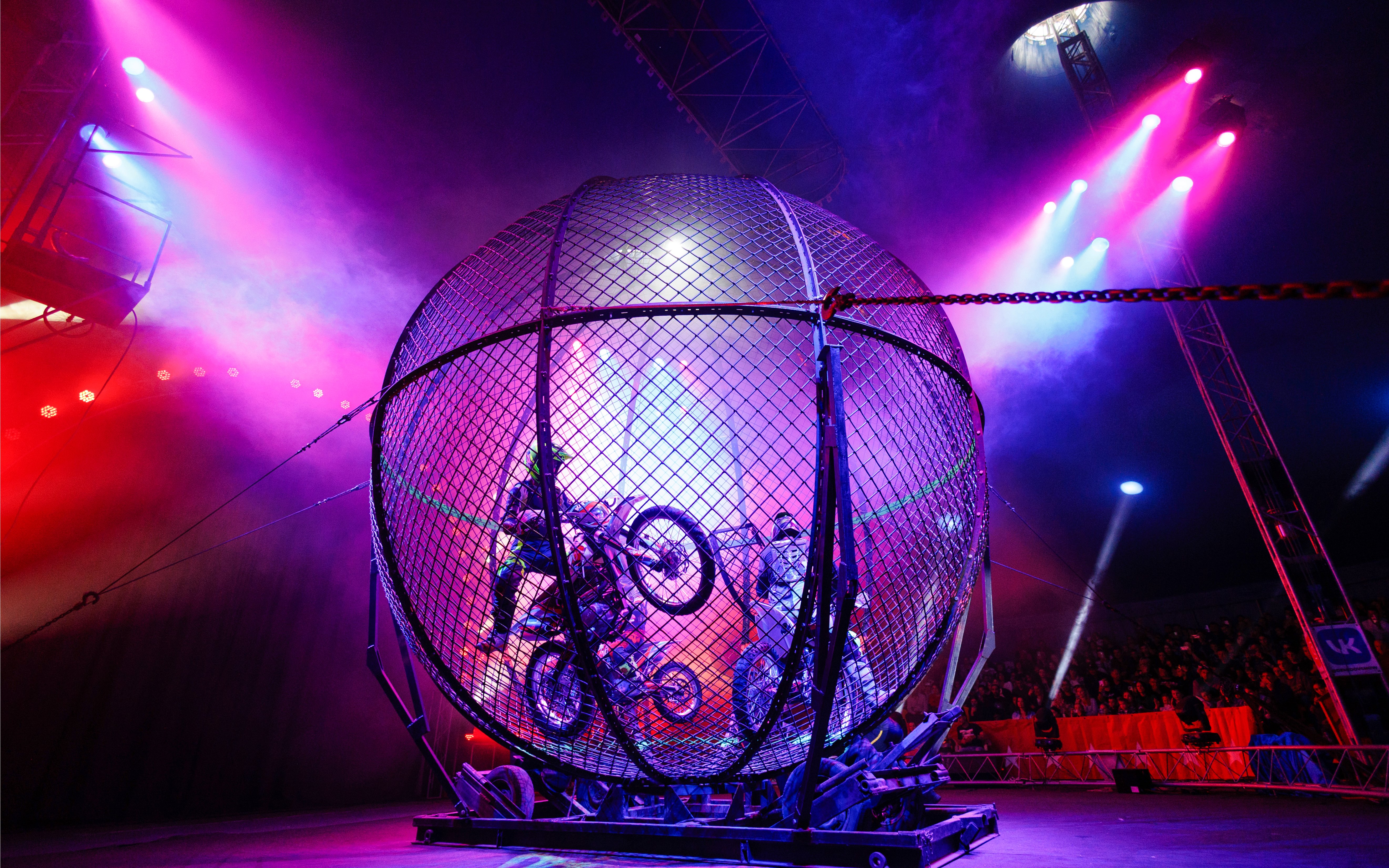 Motorcycle stunt inside a metal globe at Aqua Circus Phuket.