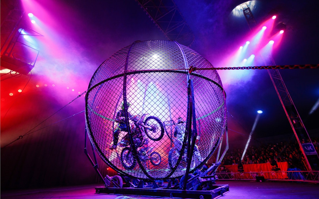 Motorcycle stunt inside a metal globe at Aqua Circus Phuket.