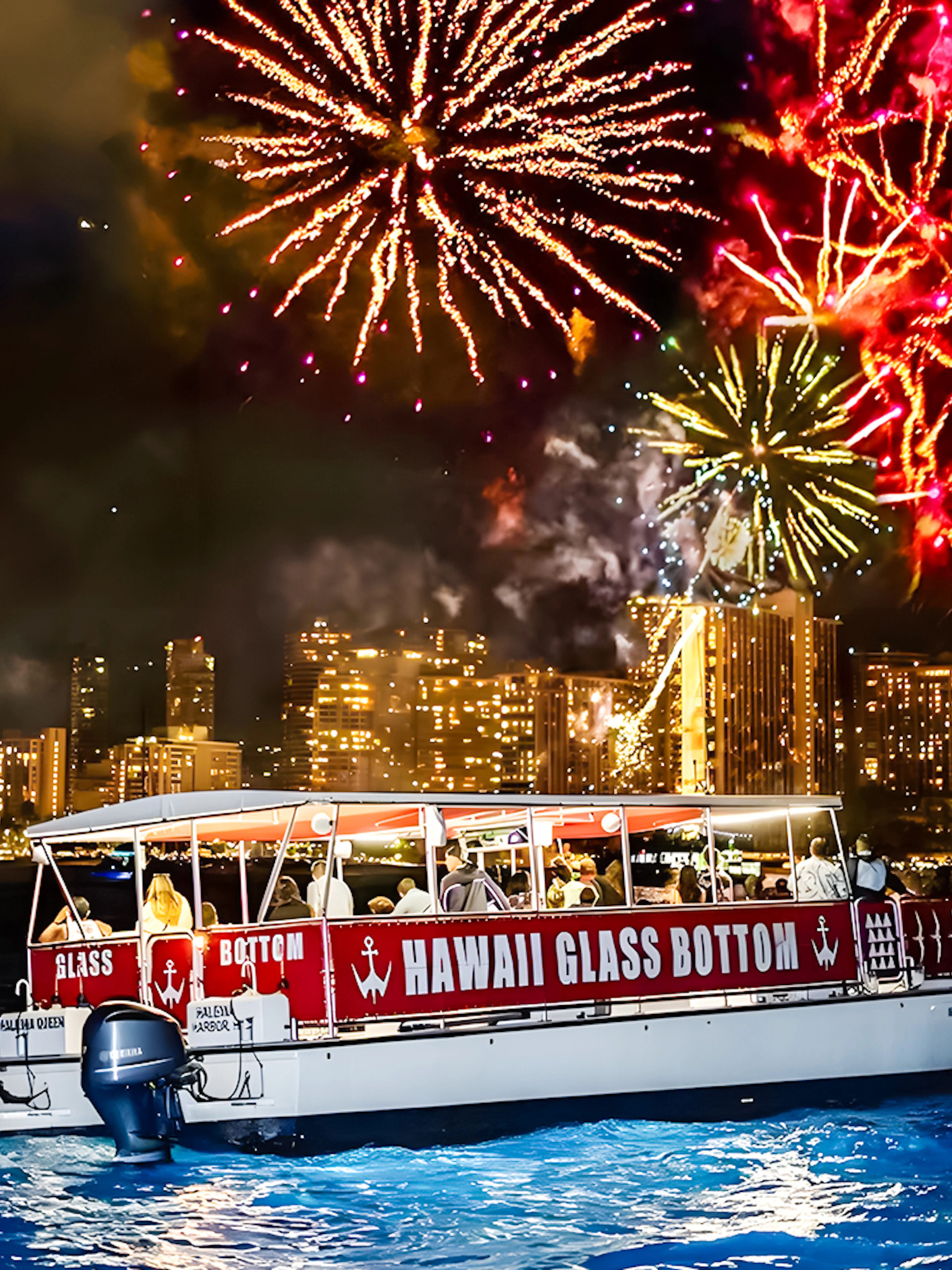 Glass-bottom boat "HAWAII GLASS BOTTOM" on water at night with fireworks over city skyline.