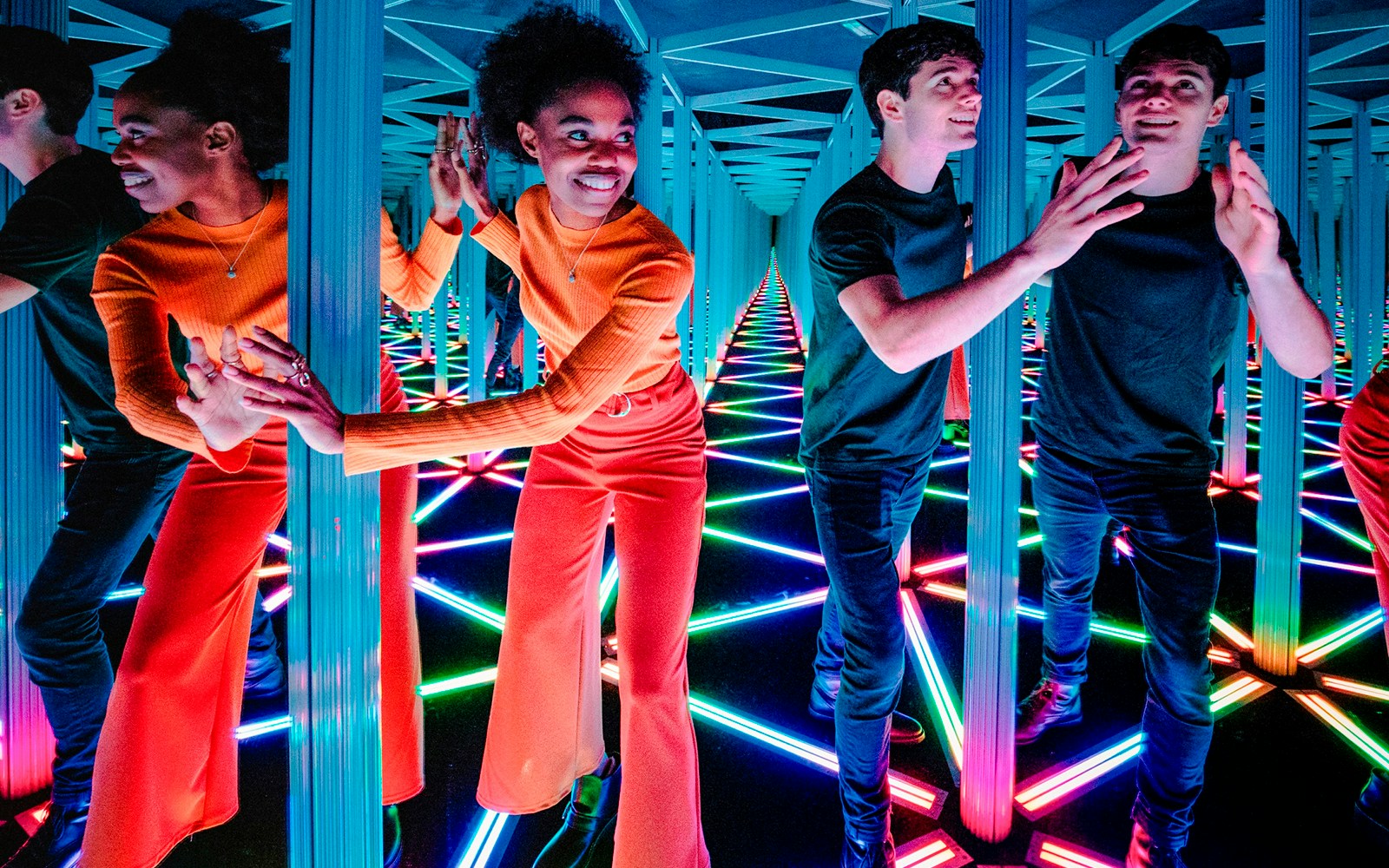 Visitors navigating the colorful Mirror Maze at Camera Obscura & World of Illusions, Edinburgh.