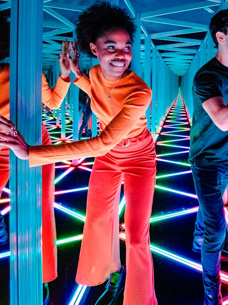 Visitors navigating the colorful Mirror Maze at Camera Obscura & World of Illusions, Edinburgh.