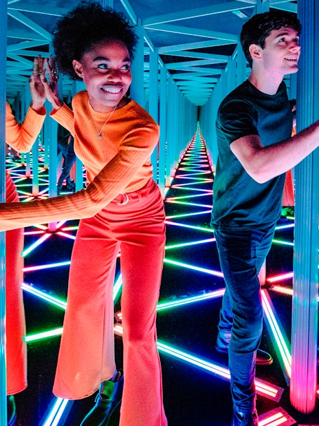 Visitors navigating the colorful Mirror Maze at Camera Obscura & World of Illusions, Edinburgh.