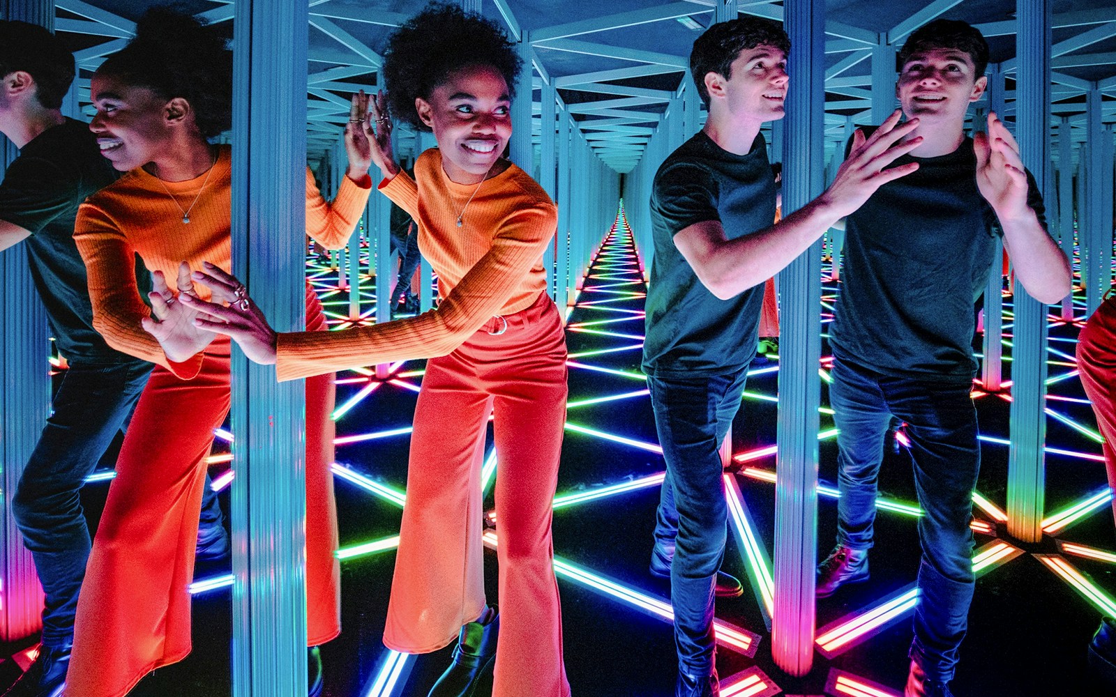 Visitors navigating the colorful Mirror Maze at Camera Obscura & World of Illusions, Edinburgh.