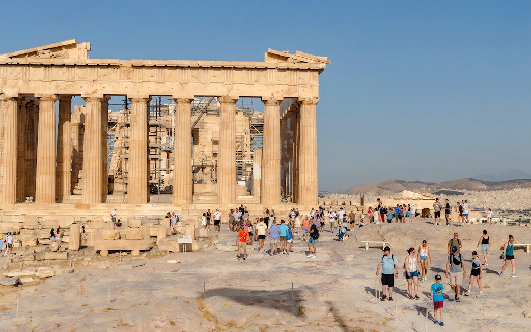 Tourists exploring the Parthenon at the Acropolis in Athens, Greece.