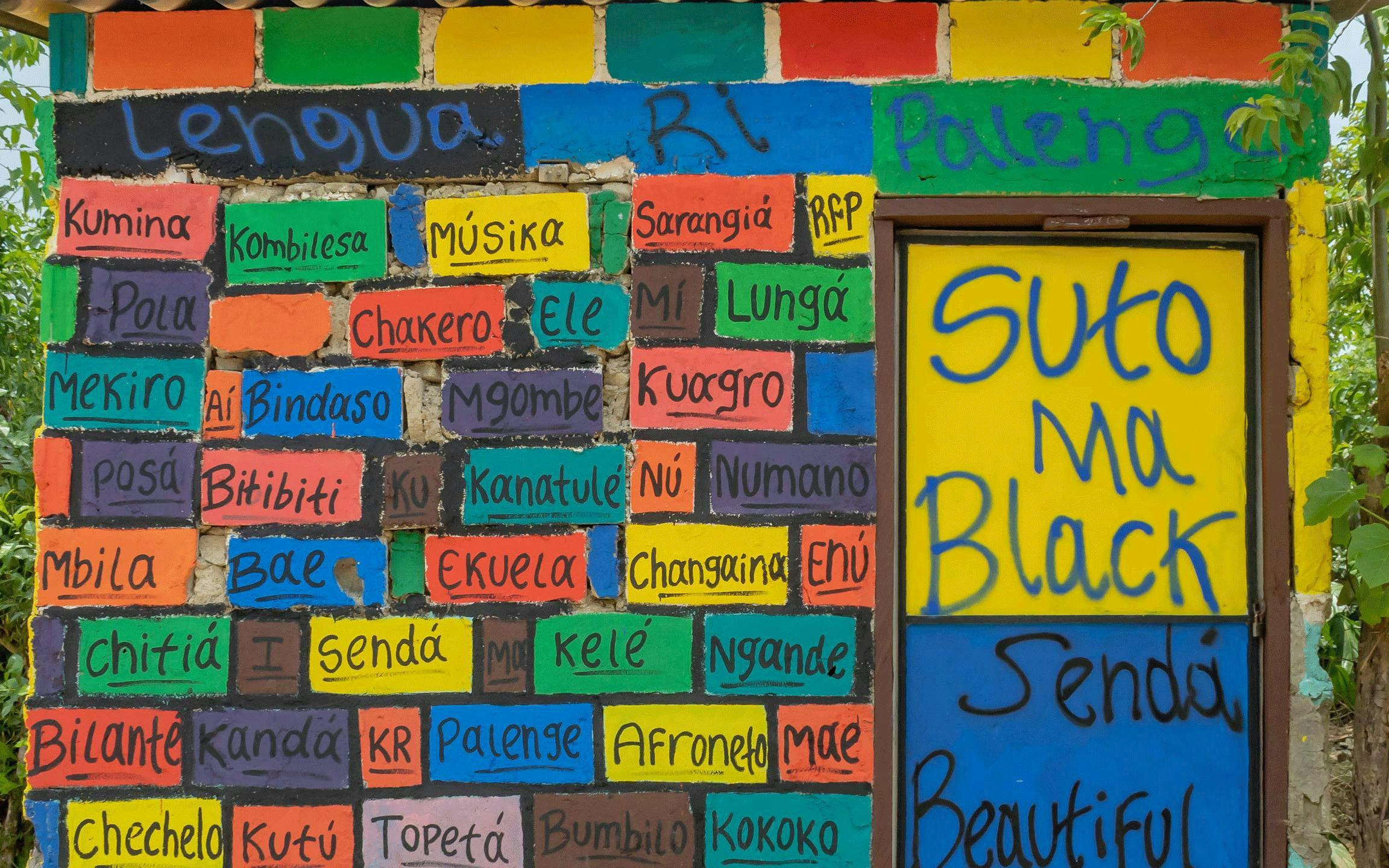 Colorful mural with Palenquero words celebrating San Basilio de Palenque culture.