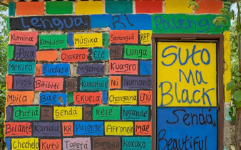 Colorful mural with Palenquero words celebrating San Basilio de Palenque culture.