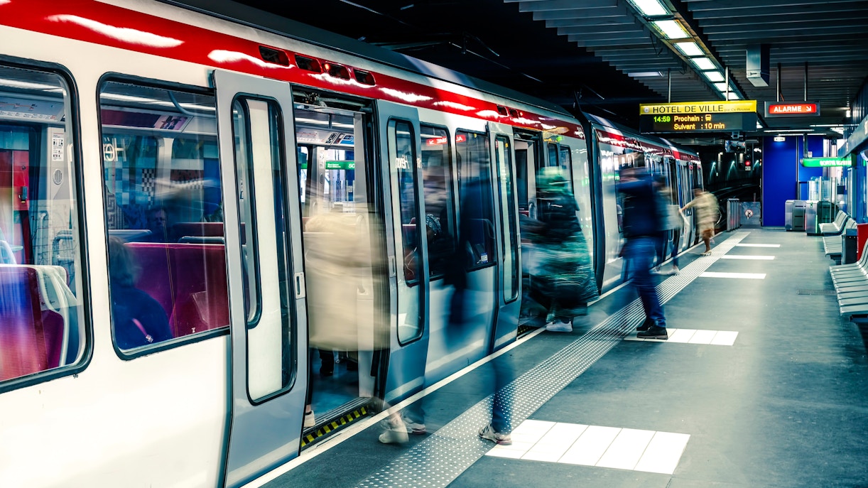 Passengers boarding a subway train at Hôtel de Ville station in Lyon.