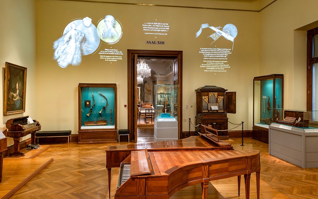 Interior of New Hofburg Palace in Vienna showcasing musical instruments and historical artifacts.