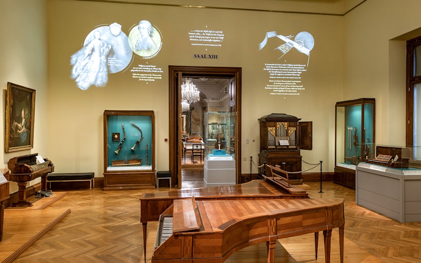 Interior of New Hofburg Palace in Vienna showcasing musical instruments and historical artifacts.