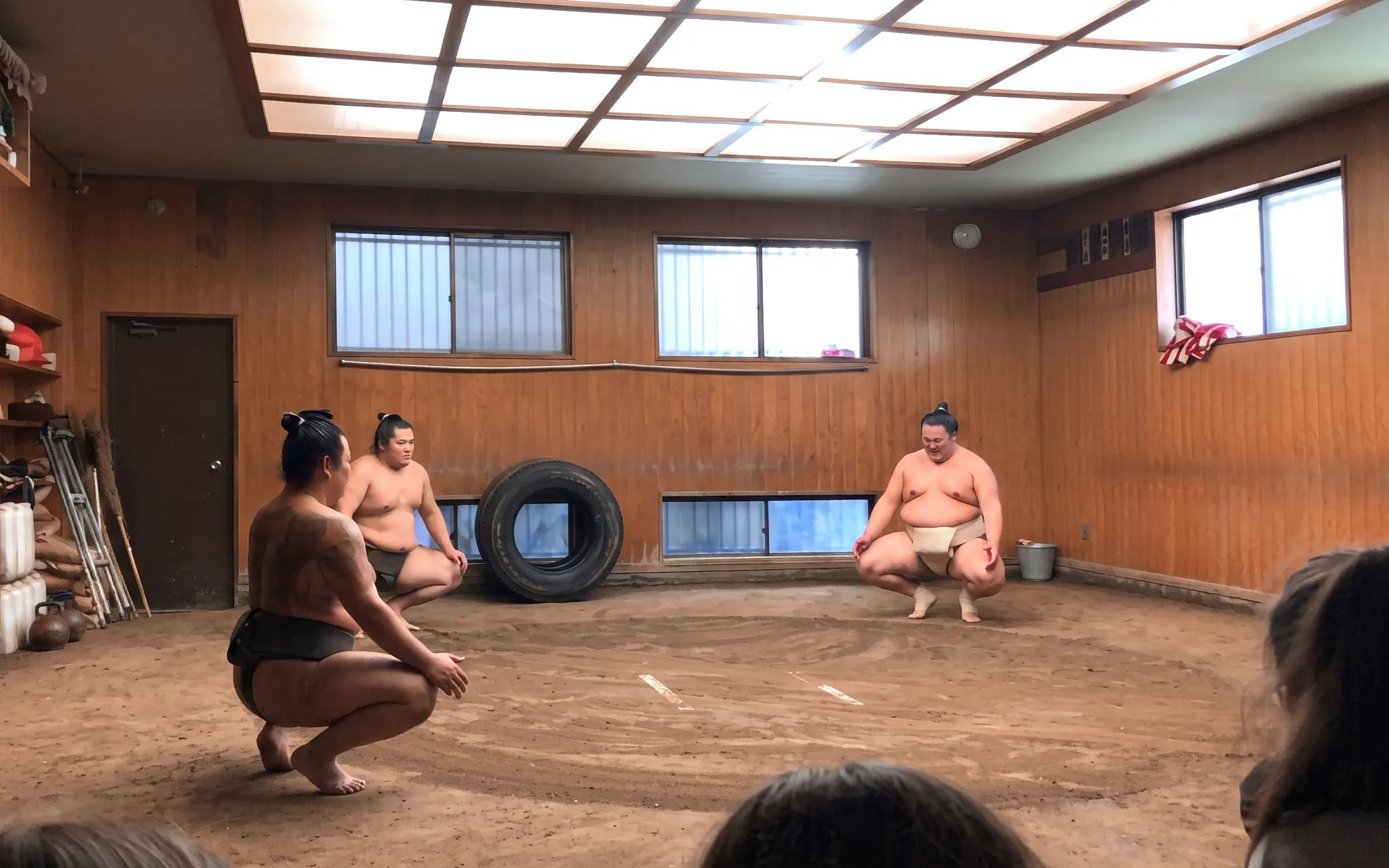Sumo wrestlers practicing in a Tokyo Ryogoku training room.