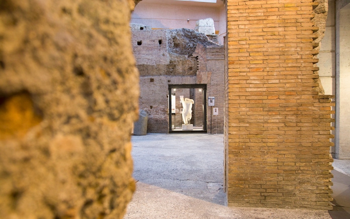Ancient brick walls and statue at Domitian Stadium, Rome.