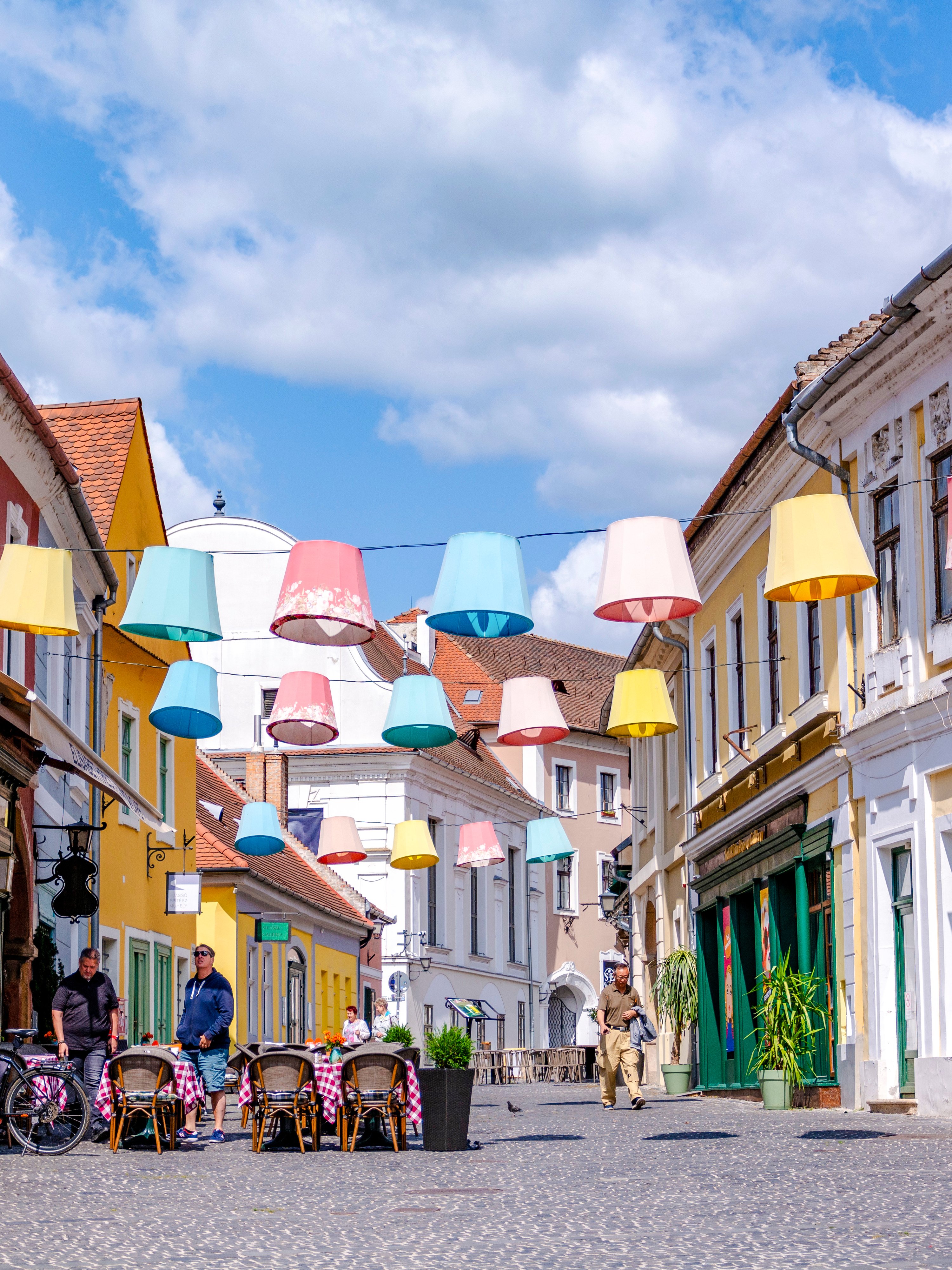Colorful lampions hanging over a cobblestone street in Szentendre, Hungary's old town.