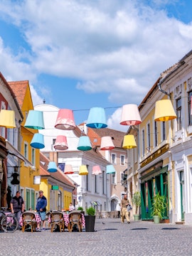 Colorful lampions hanging over a cobblestone street in Szentendre, Hungary's old town.