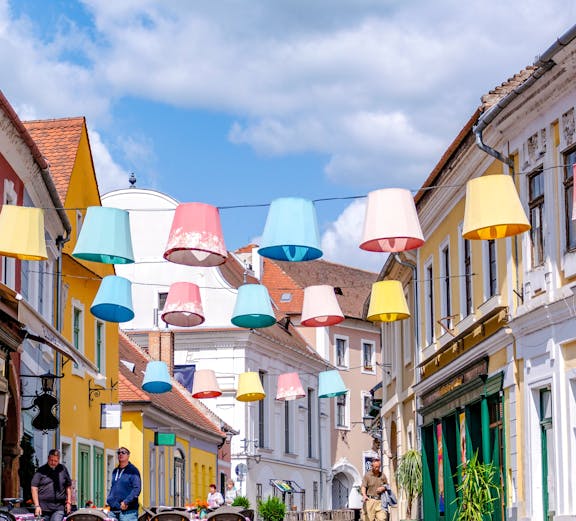 Colorful lampions hanging over a cobblestone street in Szentendre, Hungary's old town.