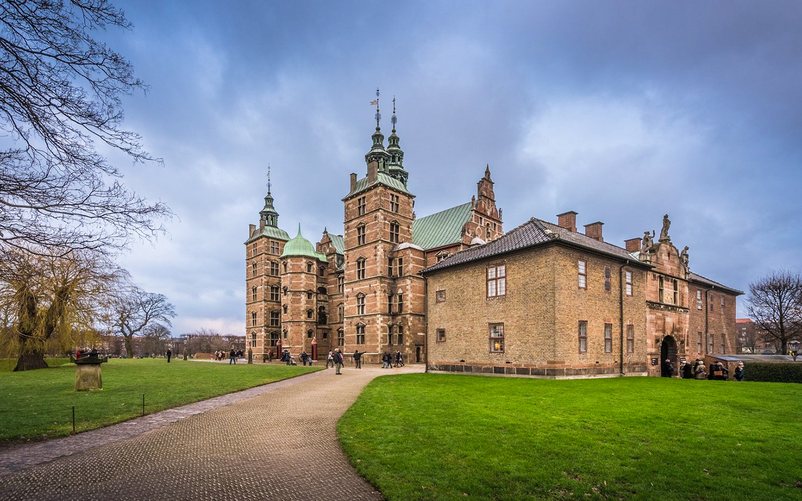 Rosenborg Castle in Copenhagen with visitors exploring the grounds.