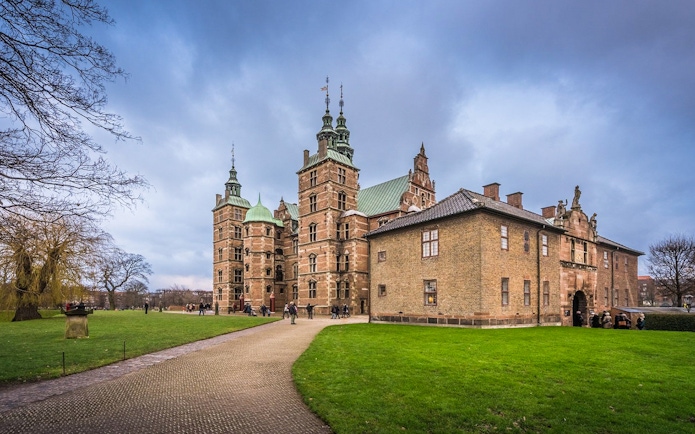 Rosenborg Castle in Copenhagen with visitors exploring the grounds.