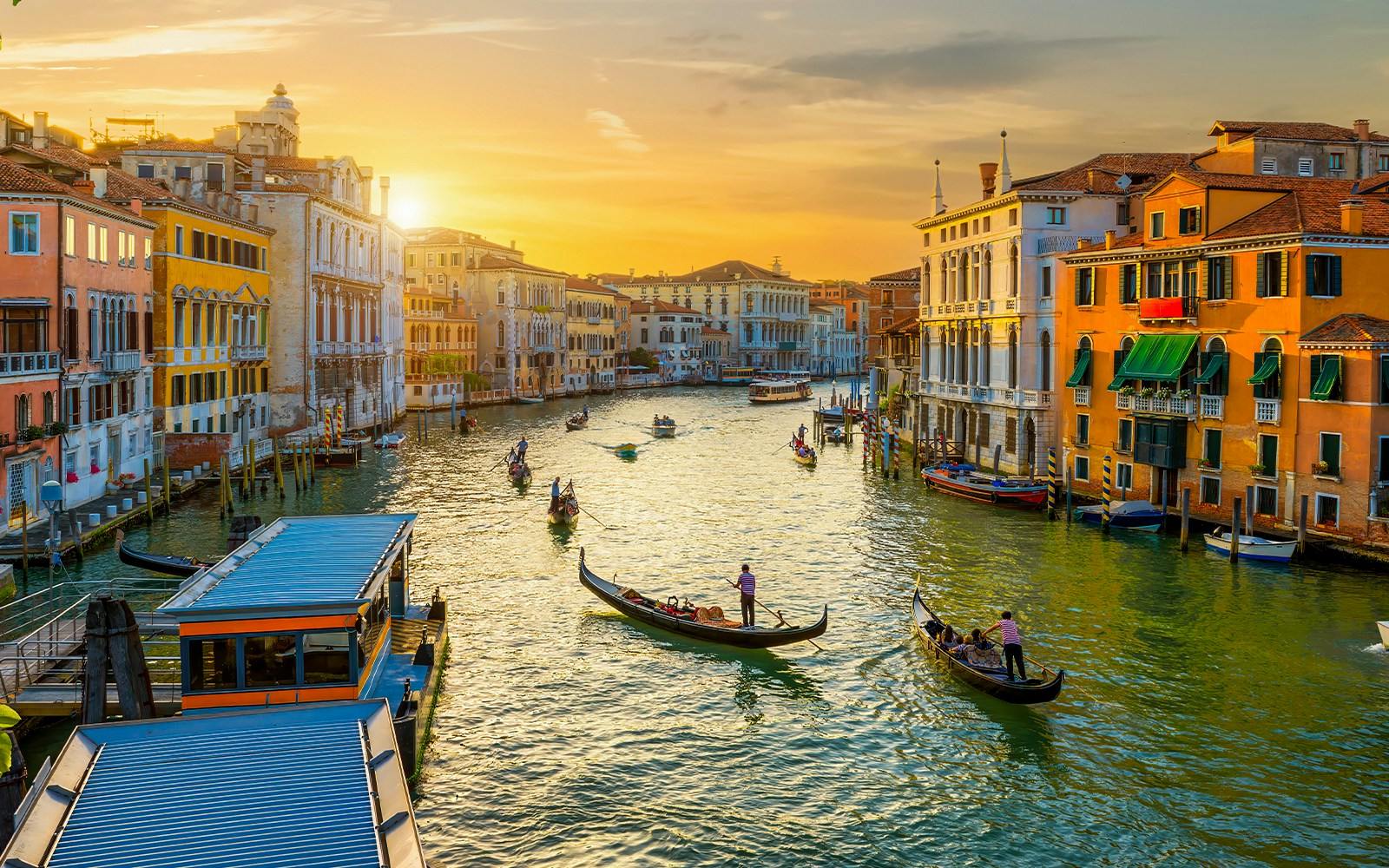 Gondolas on the Grand Canal in Venice during sunset.