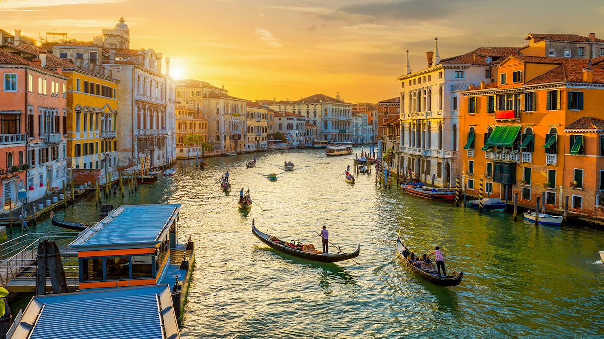 Gondolas on the Grand Canal in Venice during sunset.
