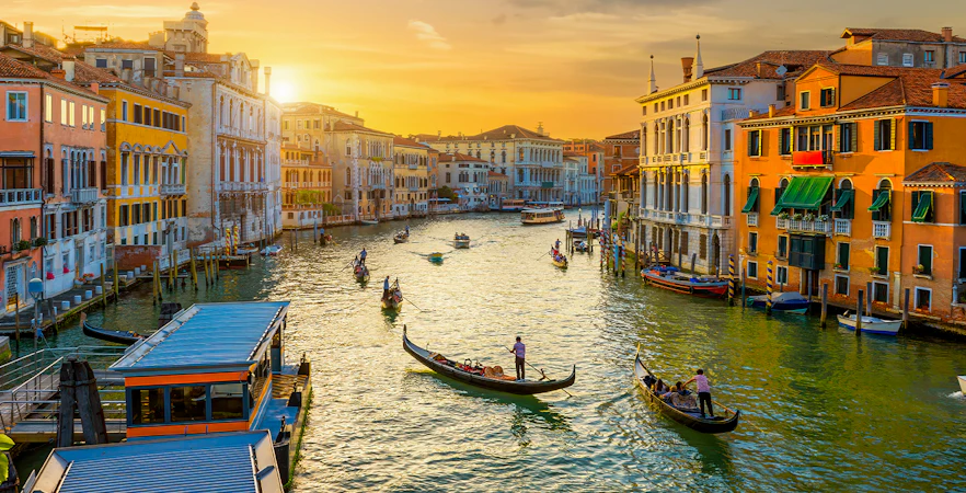 Gondolas on the Grand Canal in Venice during sunset.