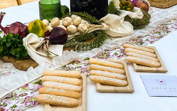 Sardinian pasta with names displayed on wooden boards at a workshop in Olbia.